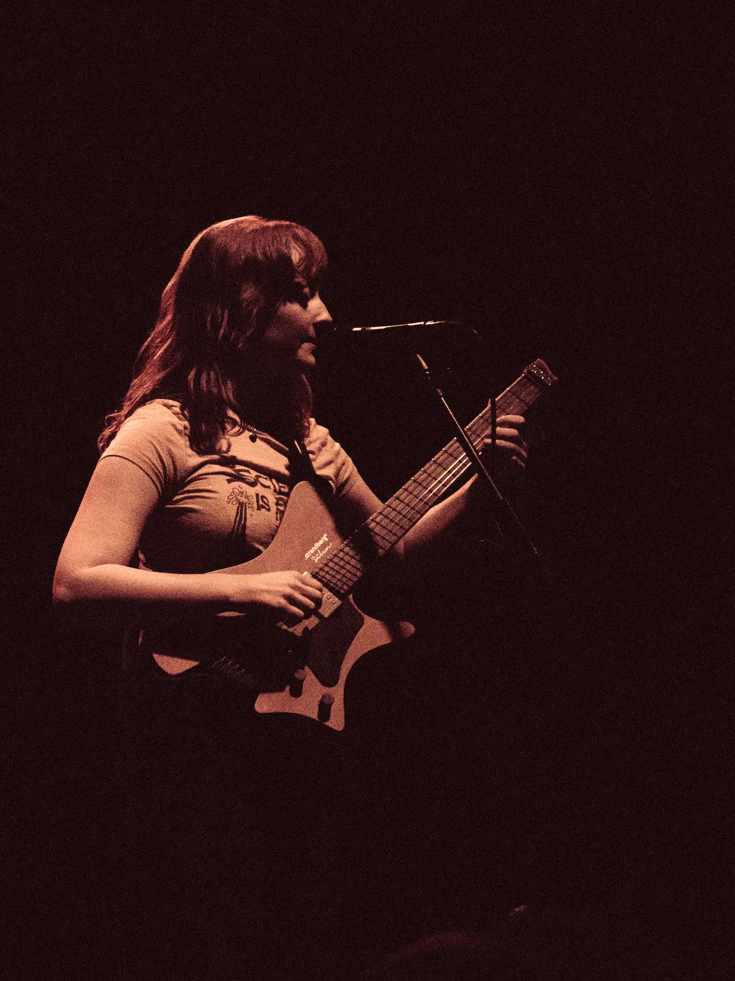 Emma Harner playing guitar and singing